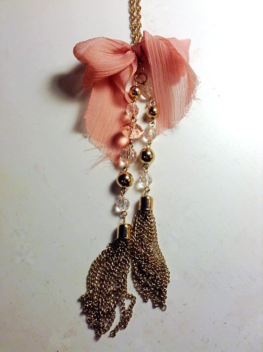 Gold fringe necklace with pink bow
