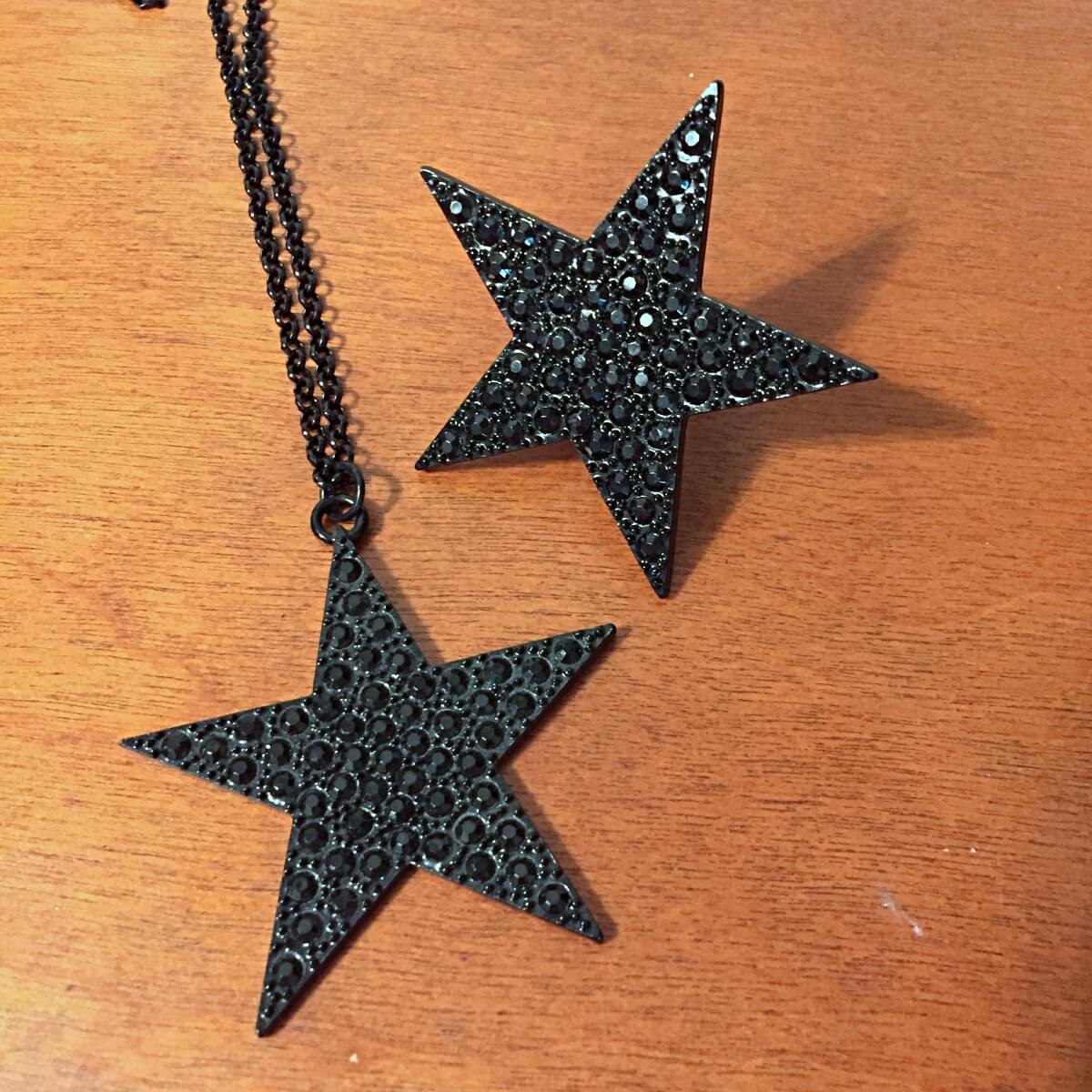 oversized black star necklace and ring