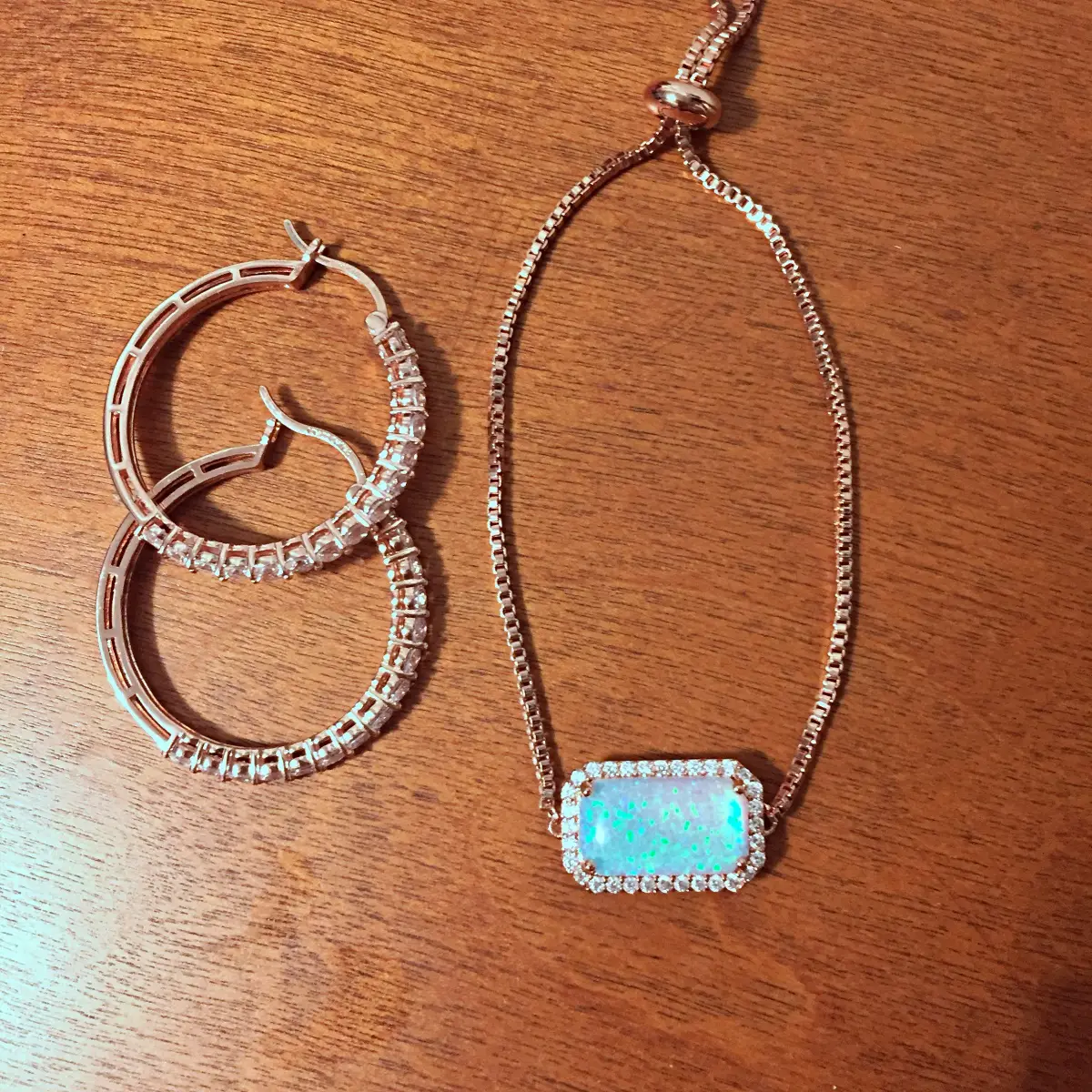 rose gold hoop earrings and opal bracelet