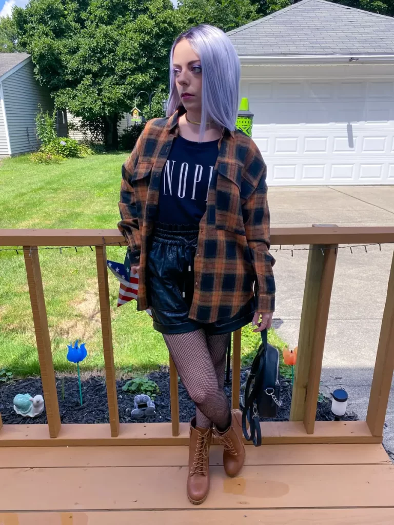 layered flannel shirt with leather shorts outfit