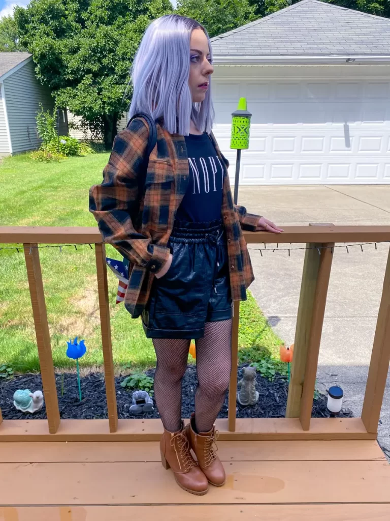 layered flannel shirt with leather shorts outfit