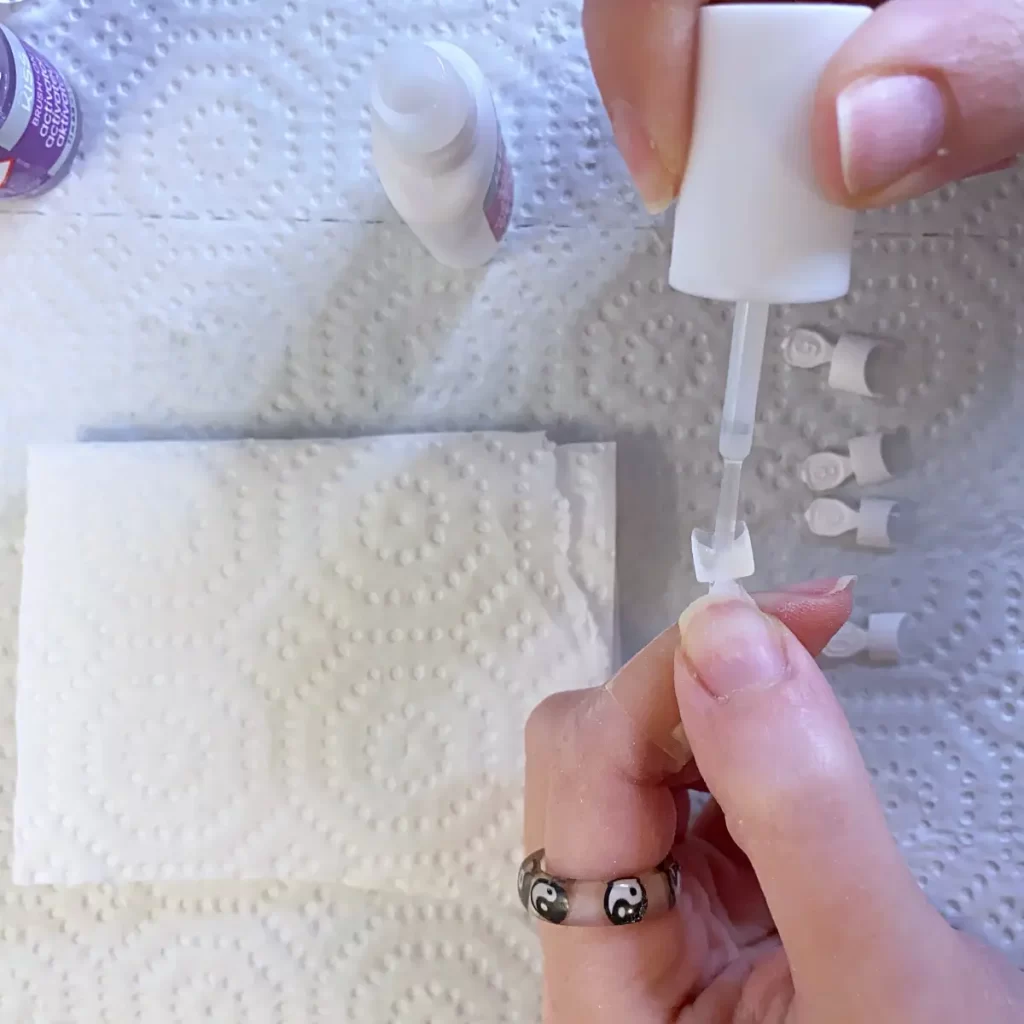 applying glue to half cover nail tops
