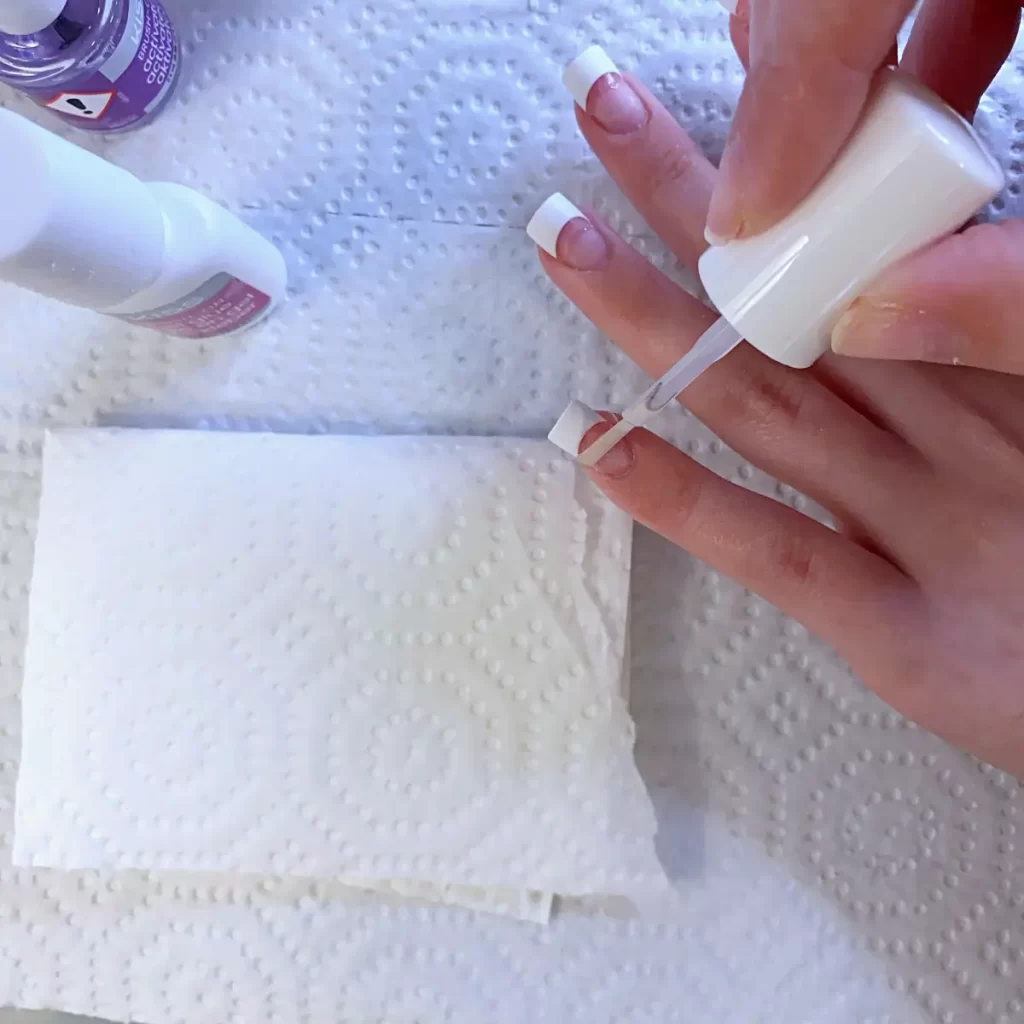 apply activator to the seam of half cover nail tips