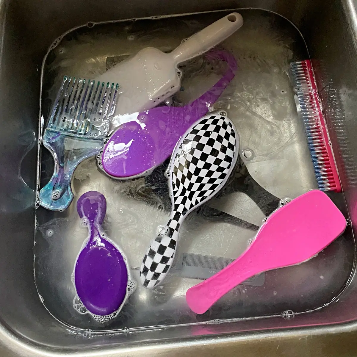 soak hairbrushes in water with soap