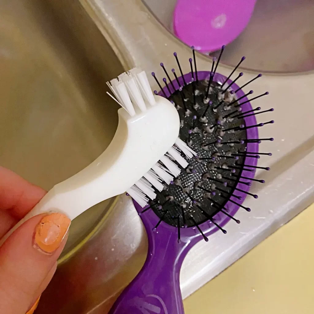 scrub hairbrushes with a denture brush to remove gray fuzzies